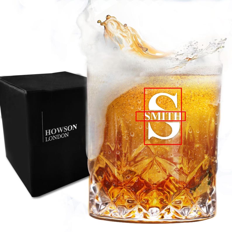 May include: A clear glass with a textured bottom filled with a golden liquid. The glass has a white monogram with the last name "SMITH" on it.