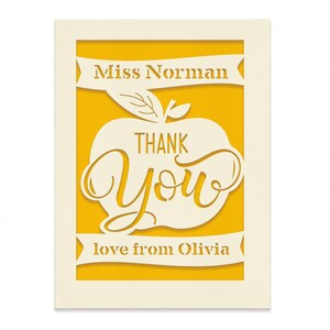 May include: A yellow card with a white apple cut out. The apple has the words "Thank You" inside. The card also has the text "Miss Norman" and "love from Olivia" on it.
