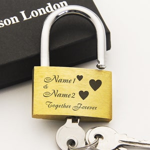 May include: Gold padlock with two keys. The padlock has the inscription "Name1 & Name2 Together Forever" with three hearts.