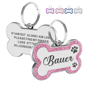 May include: Pink glitter bone-shaped dog tag with a silver ring. The tag has the text "Bauer" and two paw prints. The back of the tag has the text "If I am out alone I am lost, please find my owner, Luke 077785, 36 Luondon".