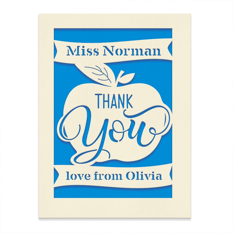May include: A white card with a blue background and a white apple with the words "Thank You" inside. The card also has the text "Miss Norman" and "love from Olivia" on it.