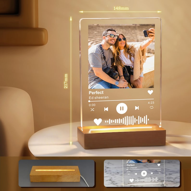 May include: A personalized acrylic photo night light with a wooden base. The light features a photo of a couple and a music player interface with the song title "Perfect" by Ed Sheeran. The acrylic panel measures 217mm high and 148mm wide.