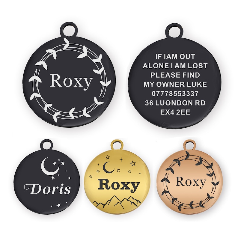 Puede incluir: Una colecci&oacute;n de etiquetas de identificaci&oacute;n redondas para mascotas en varios colores. Una etiqueta es negra con el nombre "Roxy" dentro de un dise&ntilde;o de hojas blancas. Otra etiqueta tiene el texto "If I am out alone I am lost..." con informaci&oacute;n de contacto. Otras etiquetas incluyen los nombres "Doris" y "Roxy".