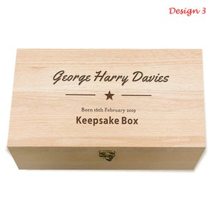 May include: A light wood keepsake box with a hinged lid and a brass latch. The box is engraved with the text "George Harry Davies", a star, and "Born 16th February 2019 Keepsake Box".