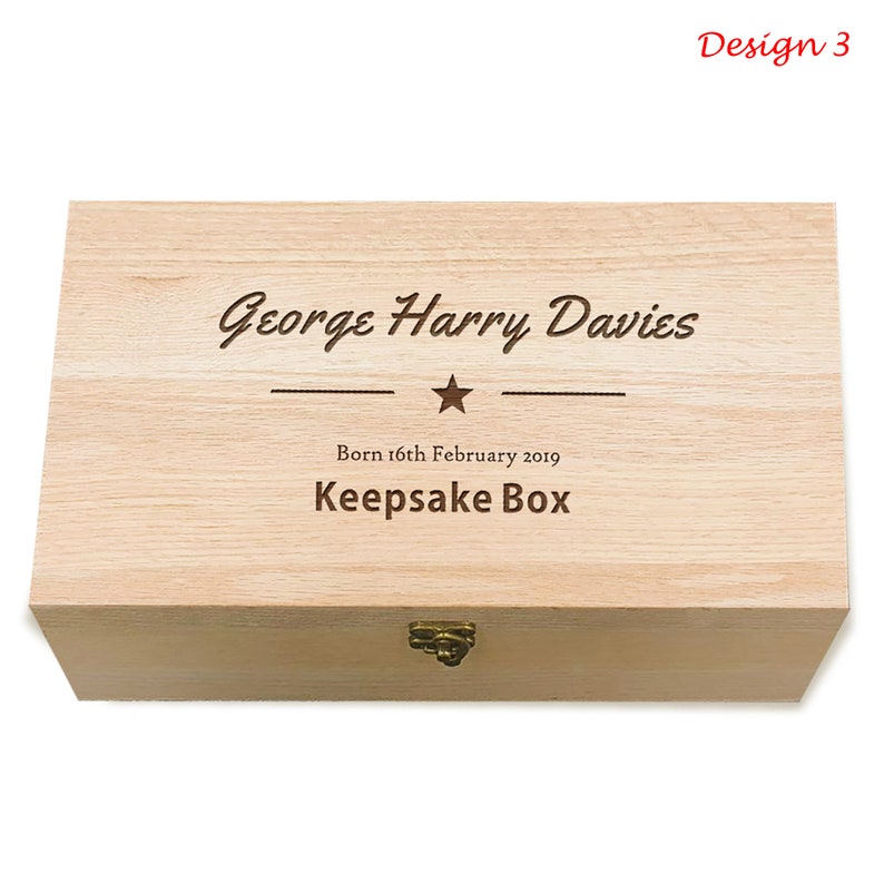May include: A light wood keepsake box with a hinged lid and a brass latch. The box is engraved with the text "George Harry Davies", a star, and "Born 16th February 2019 Keepsake Box".