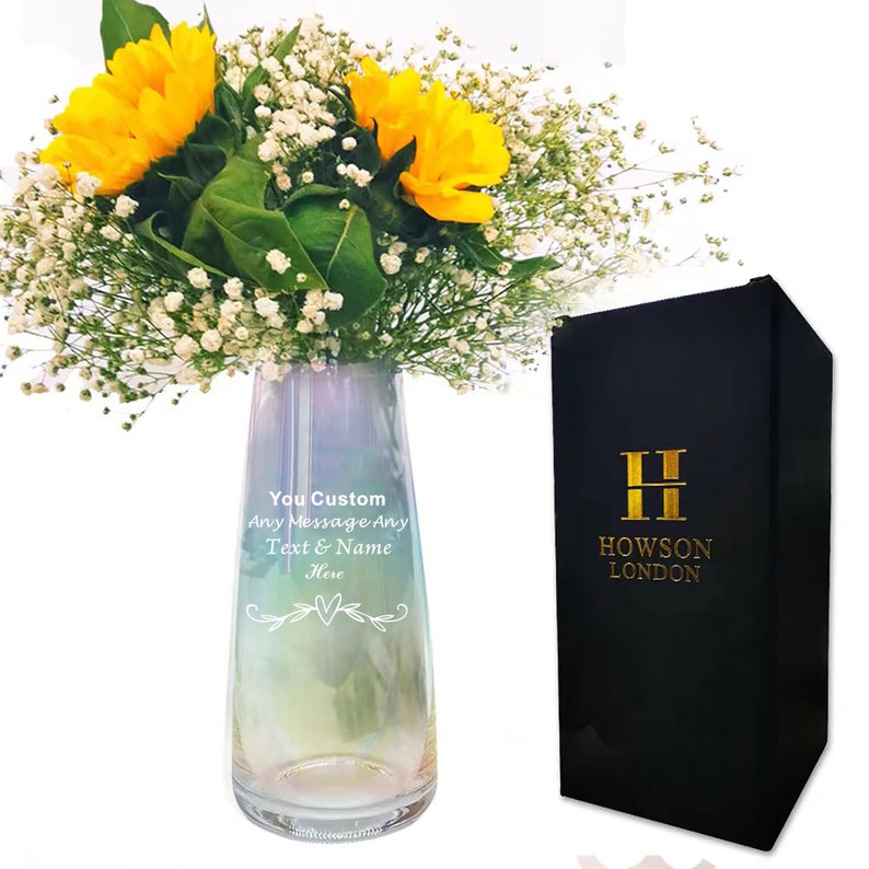 May include: A clear glass vase with an iridescent finish and a personalized message that reads "You Custom Any Message Any Text & Name Here". The vase is filled with yellow sunflowers and white baby's breath. The vase is packaged in a black box with gold lettering that reads "H Howson London".