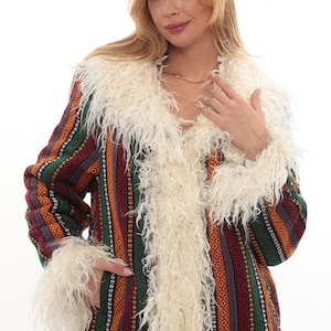 Pode incluir: Um casaco colorido com gola e punhos creme e felpudos. O casaco apresenta um design estampado com riscas verticais em vermelho, verde, laranja e turquesa. O casaco é de estilo boémio.