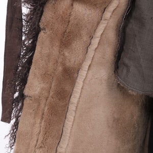 May include: A brown natural fur coat with a suede belt and a brown lining.