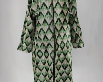 May include: A long, open-front coat with a green and beige diamond pattern. The coat has long sleeves and a stand-up collar. The fabric appears to be textured, and the coat is displayed on a mannequin.
