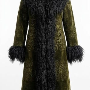 May include: Olive green long coat with black faux fur trim on the collar, cuffs, and down the front. The coat has a subtle paisley pattern. The coat is displayed on a black mannequin.