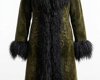 May include: Olive green long coat with black faux fur trim on the collar, cuffs, and down the front. The coat has a subtle paisley pattern. The coat is displayed on a black mannequin.