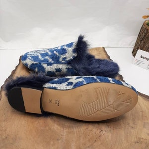 May include: Blue and white patterned slippers with a faux fur trim and a leather sole. The sole is marked "Leather Sole" and "36".