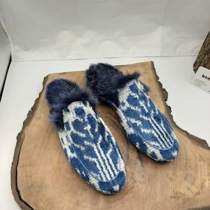 May include: A pair of blue and white patterned slippers with a faux fur trim.