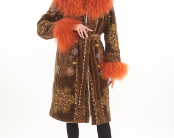 May include: A brown velvet coat with gold embroidery and a large orange fur collar and cuffs.