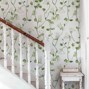 Green leaf and white sweet pea bloom wallpaper for a serene home decor.