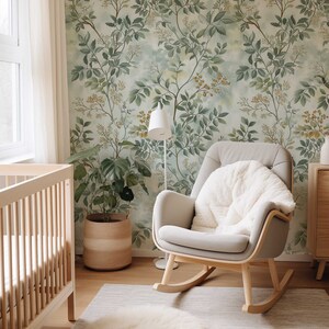 May include: A nursery room with a rocking chair, a crib, a potted plant, and a rug. The walls are covered in a green and yellow floral wallpaper.