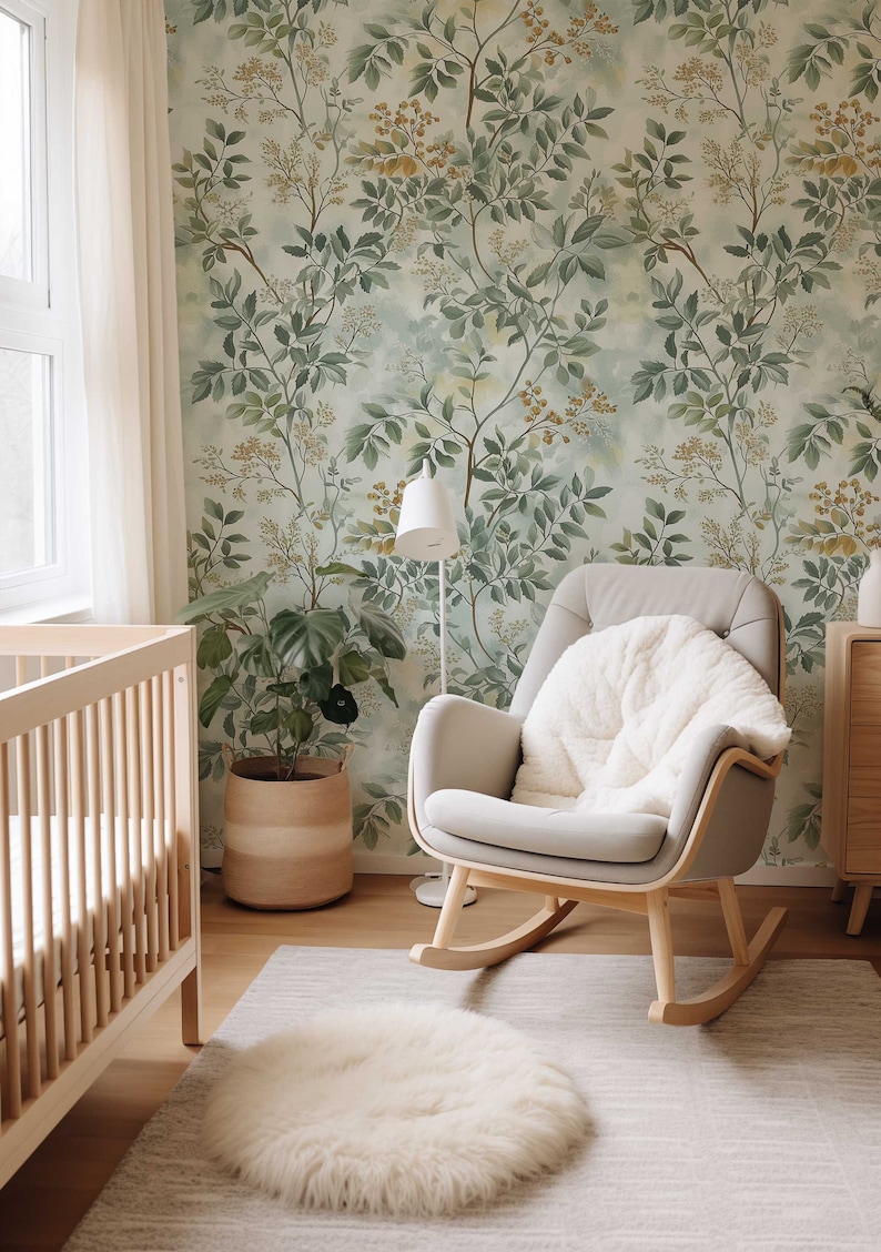 May include: A nursery room with a rocking chair, a crib, a potted plant, and a rug. The walls are covered in a green and yellow floral wallpaper.