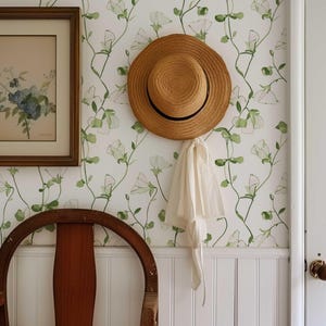 Elegant green leaf and sweet pea bloom pattern wallpaper available in peel and stick and traditional options.