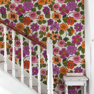 Retro floral wallpaper featuring an explosion of vibrant 70s-style flowers.