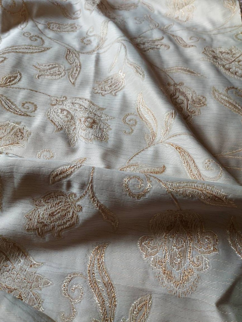 Lovely soft grey fabric with stylized flowers embossed and edged in pale brown and grey home decor fabric ships worldwide