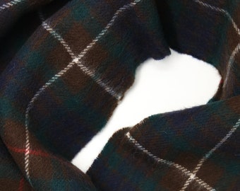 May include: A brown, green, blue, and white plaid scarf. The scarf is folded in half and the ends are overlapping.