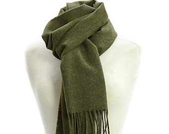 May include: A green wool scarf with fringe on the ends. The scarf is folded and draped over a white mannequin.