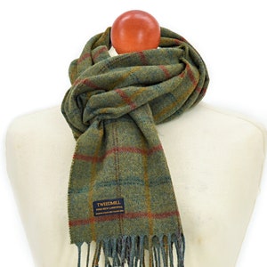 May include: Green, blue, and red plaid wool scarf with fringe. The scarf has a label that reads "Tweedmill Pure New Lambswool Made in Wales, UK".