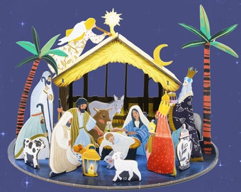May include: A layered wooden nativity scene with a star, angel, and palm trees. The scene includes figures of Mary, Joseph, baby Jesus, and the three wise men, set against a starry blue background.