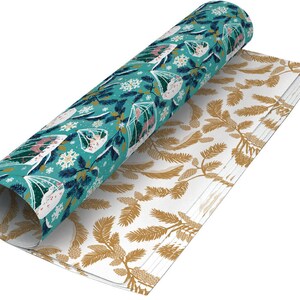 May include: Two rolls of wrapping paper with a winter theme. One roll features a teal background with white snowflakes, pine branches, and small houses. The other roll has a white background with gold pine branches.