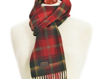 May include: A red, green, and black plaid scarf with fringe. The scarf is displayed on a mannequin. The label reads "TWEEDMILL PURE NEW LAMBSWOOL".