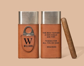 May include: Two brown leather cigar cases with a silver metal interior. One case has a cigar cutter and the initials "W" and "WILLIAMS" engraved on the front. The other case has the text "THE BEST FATHER A SON COULD ASK FOR! THANKS FOR ALL YOU DO DADI - BRANDON" engraved on the front. A brown cigar is next to the cases.
