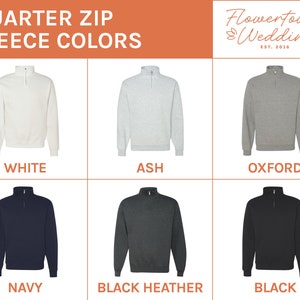 May include: Six quarter-zip fleece sweatshirts in different colours: white, ash, oxford, navy, black heather, and black.  The sweatshirts are all the same style, with a zipper up the front and a stand-up collar.  Flowertown Weddings Est. 2016 is printed in the top right corner.