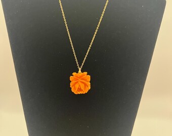 This is a vintage Bakelite rose pendant necklace.