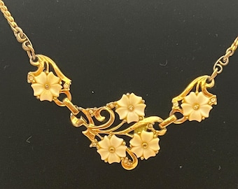 Vintage gold-tone necklace with carved lucite flowers and rhinestones.