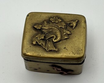 Antique Japanese brass hinged box with bird and floral relief decoration.