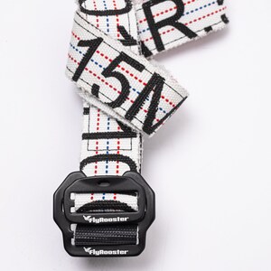 May include: White and black patterned belt with a black buckle. The buckle has the text "FlyRooster" printed on it.
