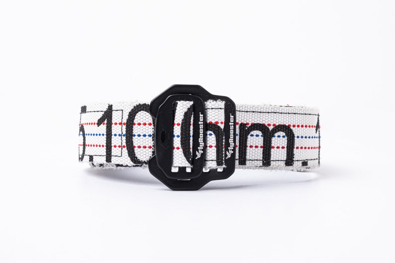 May include: A white woven belt with a black buckle. The belt has red and blue stripes and the text "Flybooster" printed on it.
