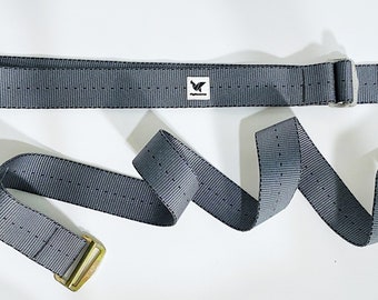May include: A gray adjustable strap with a silver buckle and a gold buckle. The strap has a small white label with the text "Flybird" on it.