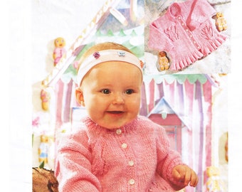 May include: A pink knitted baby cardigan with a button closure and a delicate lace pattern. The cardigan is shown on a baby wearing a floral print outfit. The pattern number is PBN 5148 and the size is 0-7 years, 16-26 inches.