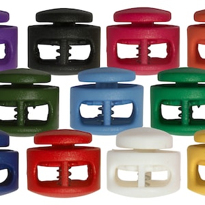 May include: Assortment of 10 plastic toggle clasps in various colours, including purple, black, red, orange, green, blue, white, and yellow. Each clasp has a double-loop design.