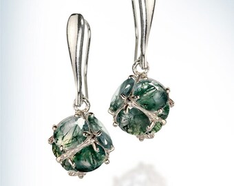 May include: A pair of silver dangle earrings with green agate stones. The stones are faceted and have a natural, organic look.