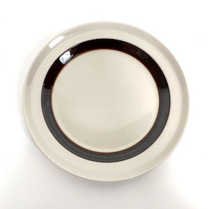 May include: A white ceramic plate with a brown band around the edge. The plate has a decorative pattern of small circles around the edge.
