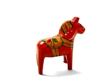May include: A bright red wooden horse figurine featuring hand-painted yellow and green floral patterns on its back and mane. The horse stands on four sturdy legs with a smooth, glossy finish, showcasing detailed decorative brushwork across its body.