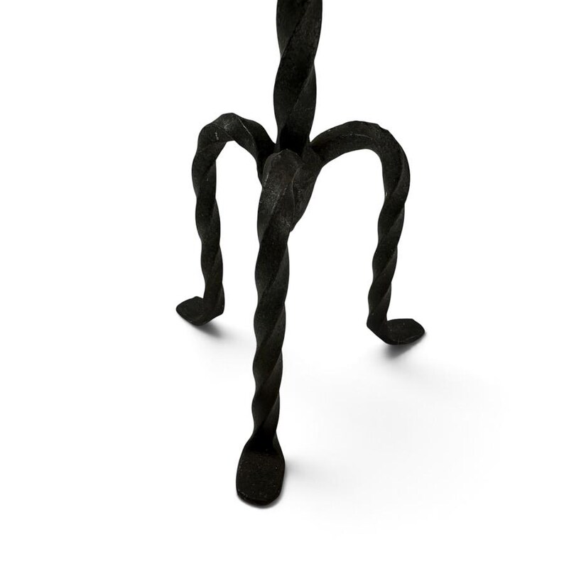 May include: A black metal stand featuring three legs with a distinct twisted, spiral design. The legs converge at a central point, supporting a vertical structure that extends upward. The metal has a textured, matte finish throughout the piece.