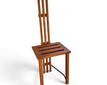 May include: A tall wooden chair featuring a square seat constructed from three horizontal slats and a high, narrow backrest composed of three vertical wooden bars. The chair has four straight legs and a thin metal support bar connecting the legs.