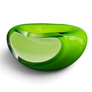 May include: A smooth, rounded glass bowl featuring a vibrant lime green exterior that transitions into a lighter, opaque chartreuse center. The bowl has a thick, polished rim and a curved, organic shape with a glossy, reflective surface finish.