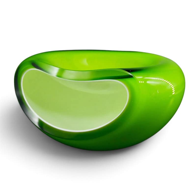May include: A smooth, rounded glass bowl featuring a vibrant lime green exterior that transitions into a lighter, opaque chartreuse center. The bowl has a thick, polished rim and a curved, organic shape with a glossy, reflective surface finish.