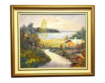 May include: An oil painting in a gold frame depicting a landscape with a dirt path leading toward a small orange cabin near a body of water. The scene features a tall birch tree, dense green foliage, a wooden fence, and a distant sailboat.