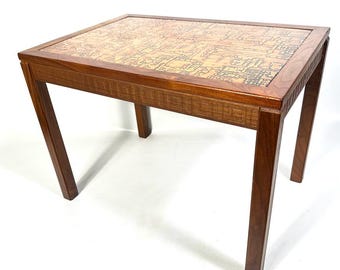 May include: A rectangular wooden side table with a patterned top. The table has a dark brown finish with a geometric design on the tabletop. The legs are angled, and the table is approximately 24 inches long, 18 inches wide, and 20 inches high.