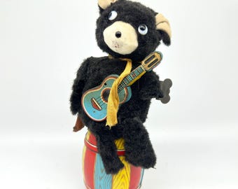 1950s nomura “jolly guitarist” bear – vintage japanese wind-up tin & plush musical toy